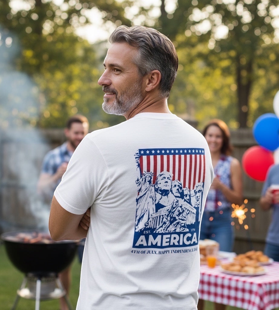 JSD Apparel white cotton t-shirt with patriotic graphic featuring the Statue of Liberty, Mount Rushmore, and American flag.
