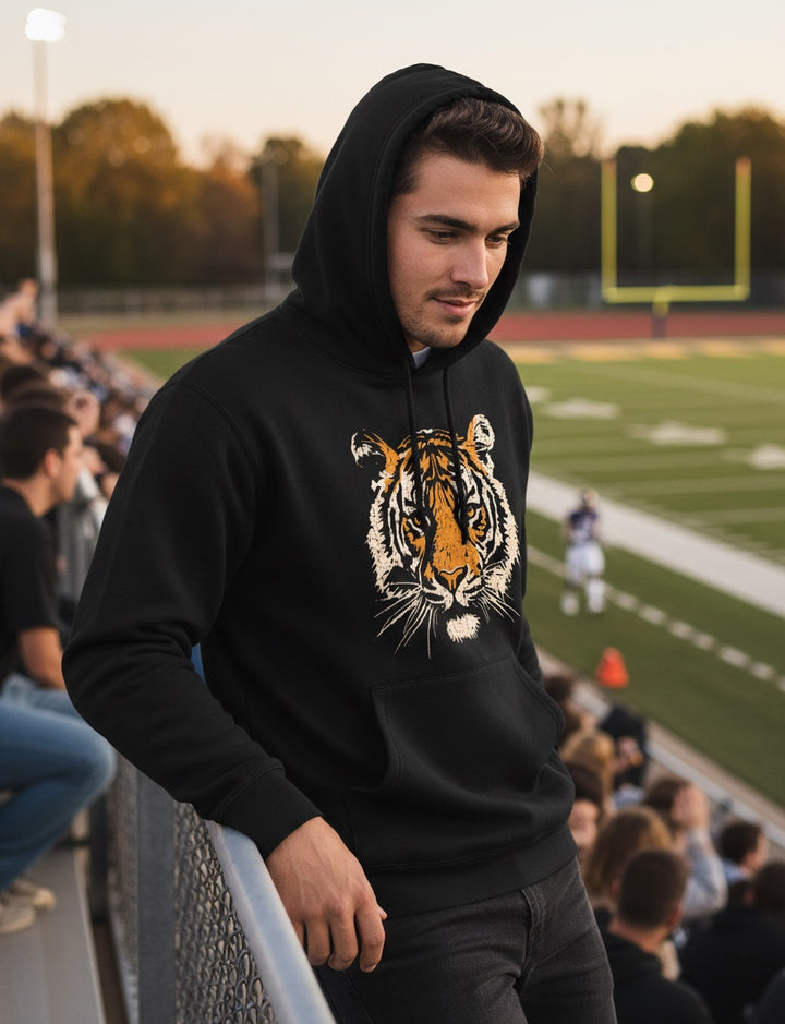 JSD Apparel black heavyweight hoodie with a vintage tiger graphic worn by a man at a football stadium