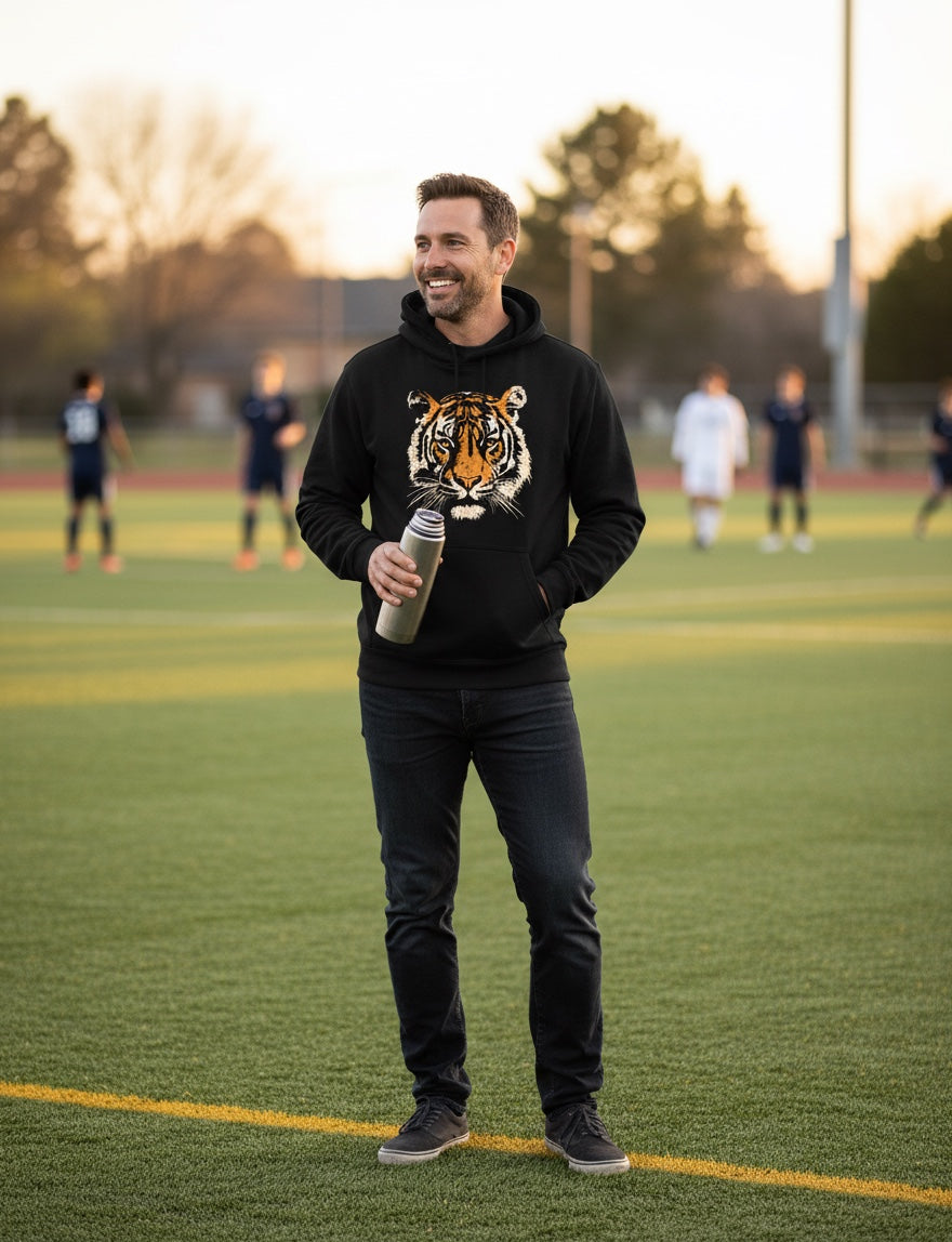 JSD Apparel Fierce Spirit black heavyweight hoodie with a vintage tiger graphic worn by a man on a soccer field
