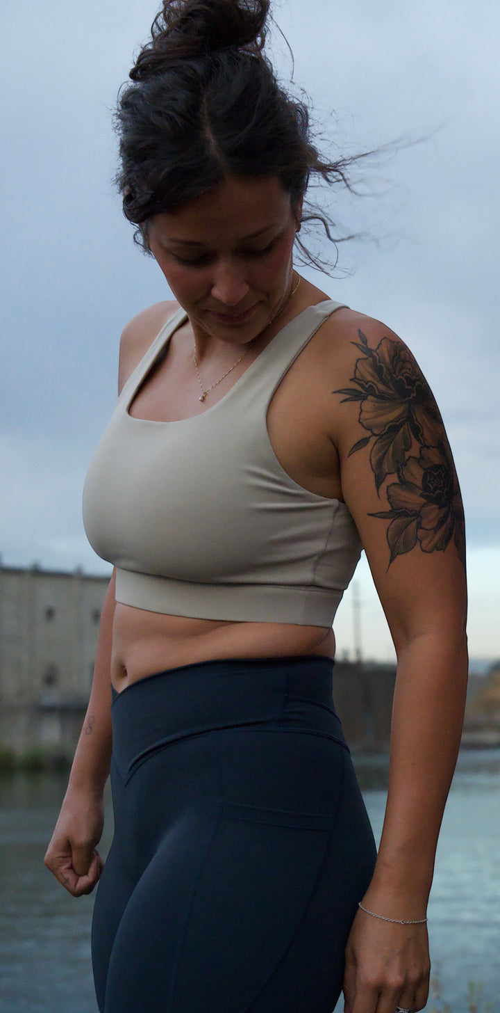 JSD Apparel blueberry high-waisted leggings with side pockets and V-front waistband worn by a woman outdoors