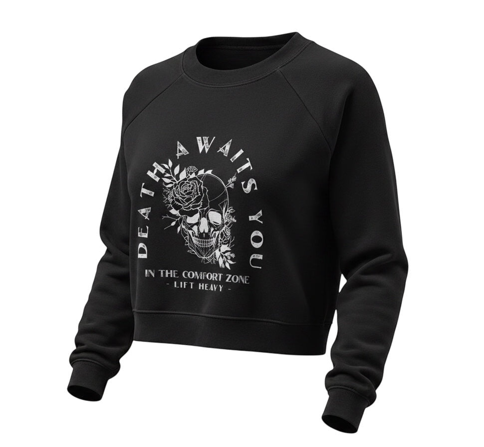 JSD Apparel black cropped fleece pullover with Death Awaits You skull and floral graphic print and raglan sleeves.