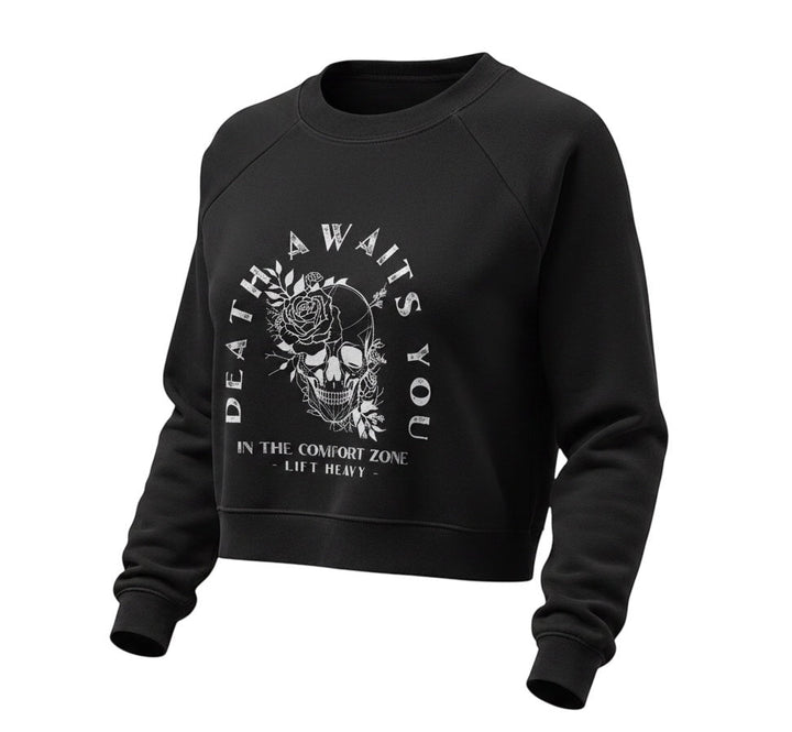 JSD Apparel black cropped fleece pullover with Death Awaits You skull and floral graphic print and raglan sleeves.