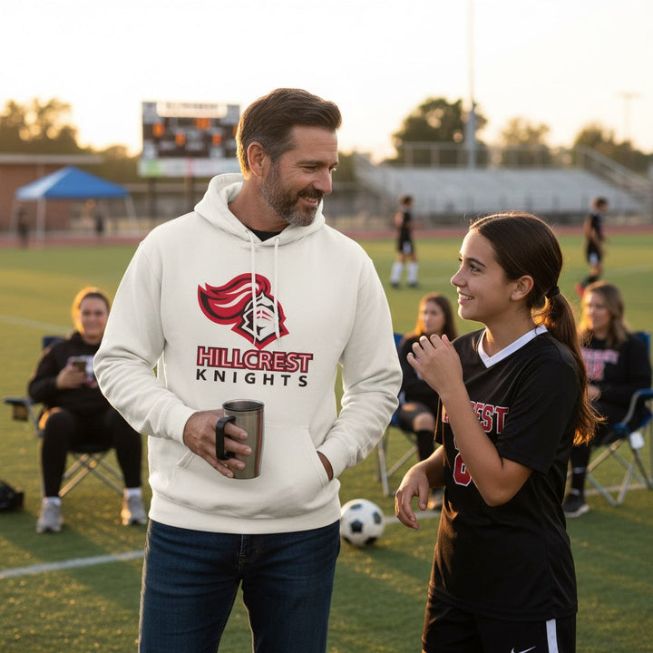 JSD Apparel off-white heavyweight hoodie with Hillcrest Knights logo worn by a man on a sports field