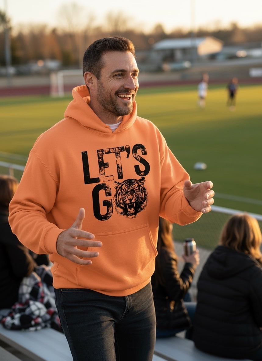 Man wearing orange JSD Apparel Idaho Falls Tigers hoodie with distressed Let&