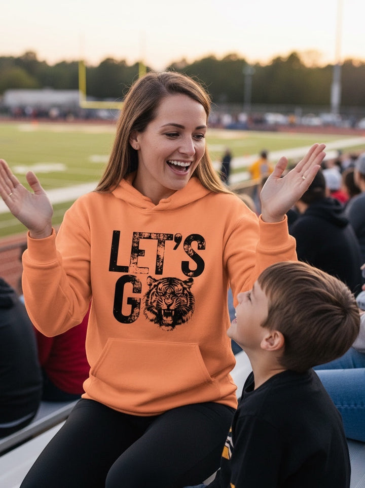 Woman wearing an orange JSD Apparel Idaho Falls Tigers hoodie with distressed Let&