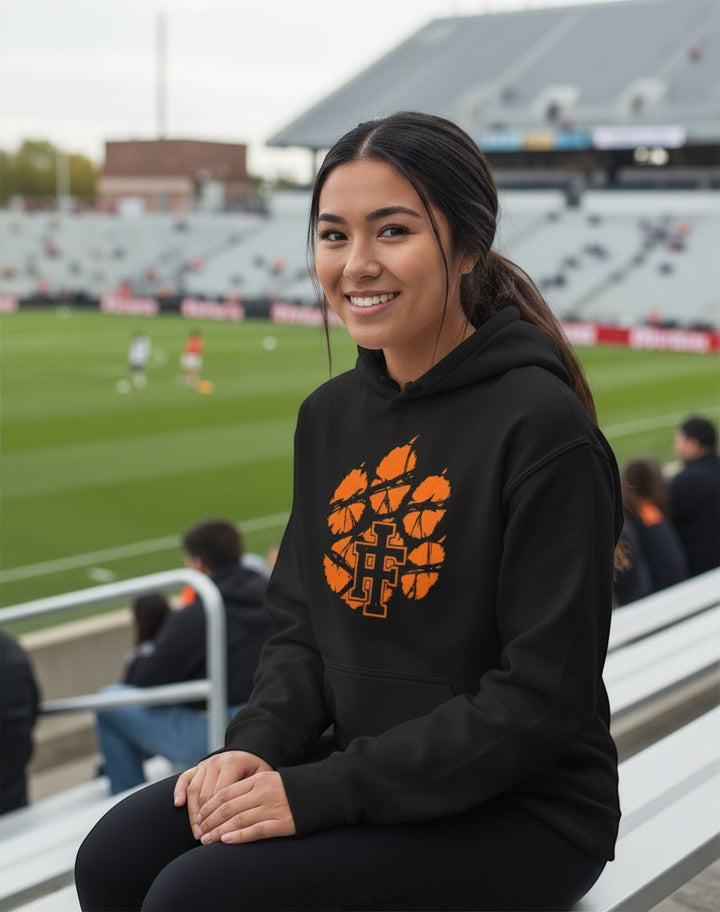 JSD Apparel black heavyweight hoodie featuring a distressed orange Idaho Falls Tigers paw logo worn by a young woman.