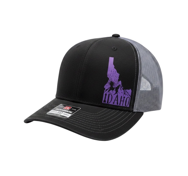 JSD Apparel Idaho Sunrise Richardson 115 trucker hat in black and grey with a purple Idaho state graphic print.