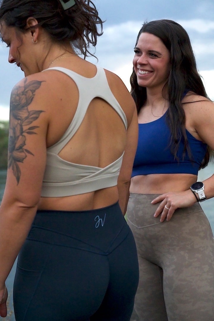 Two women wearing JSD Apparel Jenvae high-waisted leggings with contouring seams and subtle leopard print.