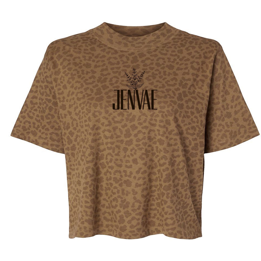 JSD Apparel Jenvae boxy cropped t-shirt in desert tan with all-over leopard print and botanical logo graphic.