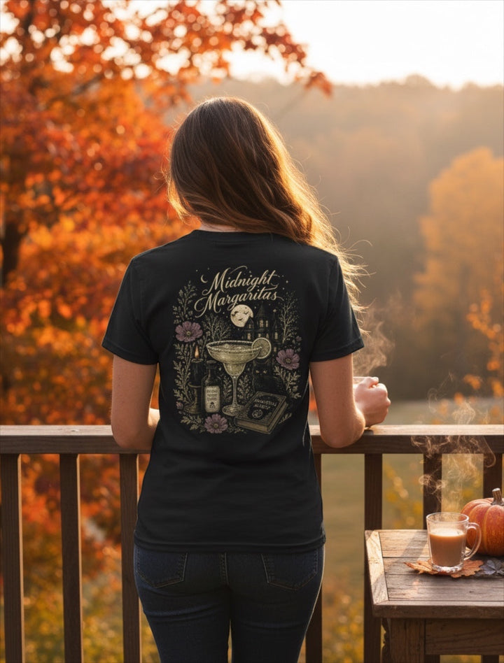 JSD Apparel black unisex tee featuring a detailed back graphic of a margarita, moonlit house, and cat in autumn.