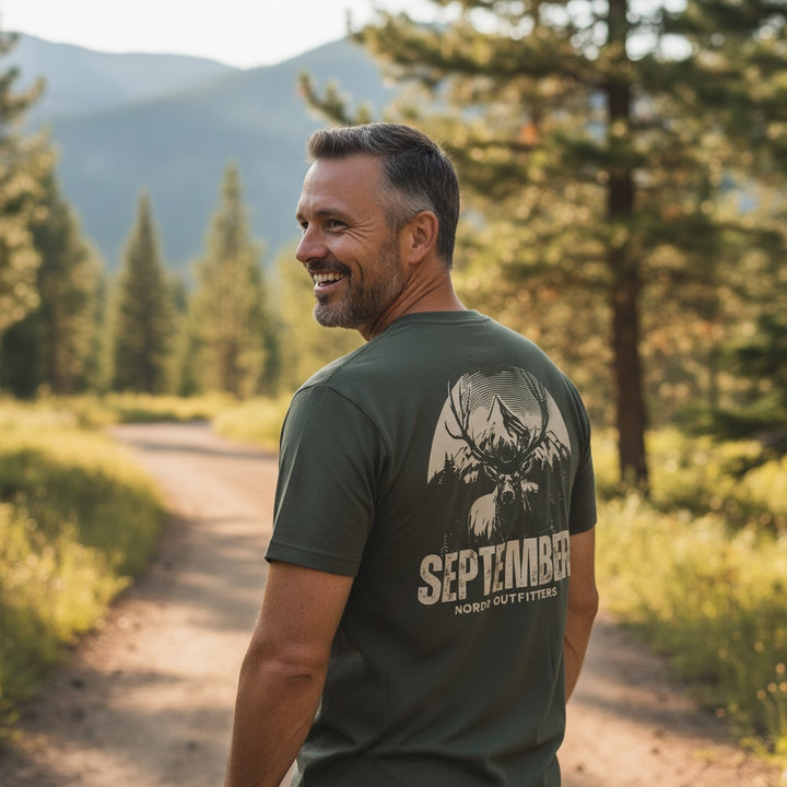 JSD Apparel olive green cotton t-shirt with vintage elk and mountain graphic on back, "September Nordr Outfitters" text.