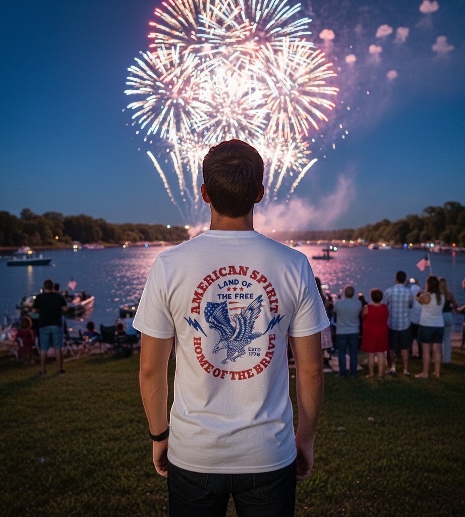 JSD Apparel white cotton t-shirt with vintage eagle graphic and patriotic text, worn by a man watching fireworks.