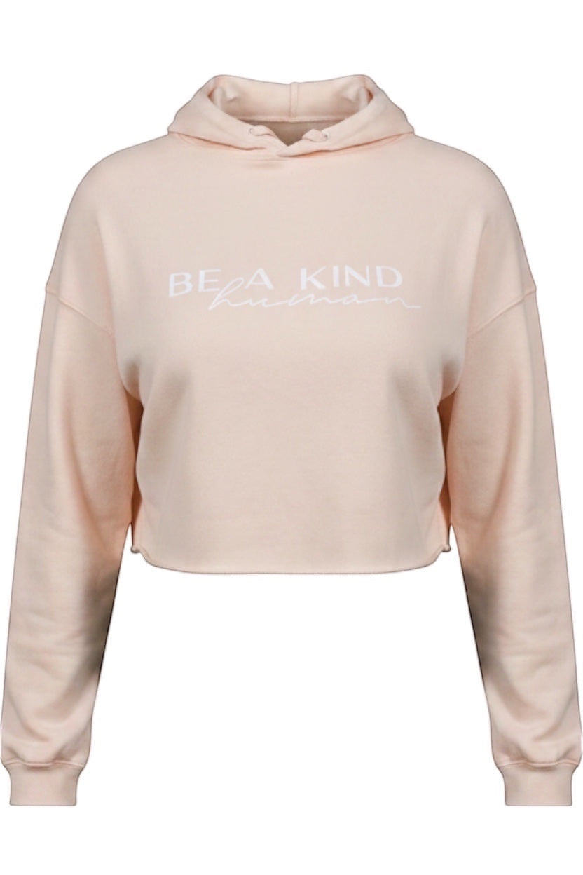 JSD Apparel light pink cropped hooded sweatshirt with Be A Kind Human text in white on the front