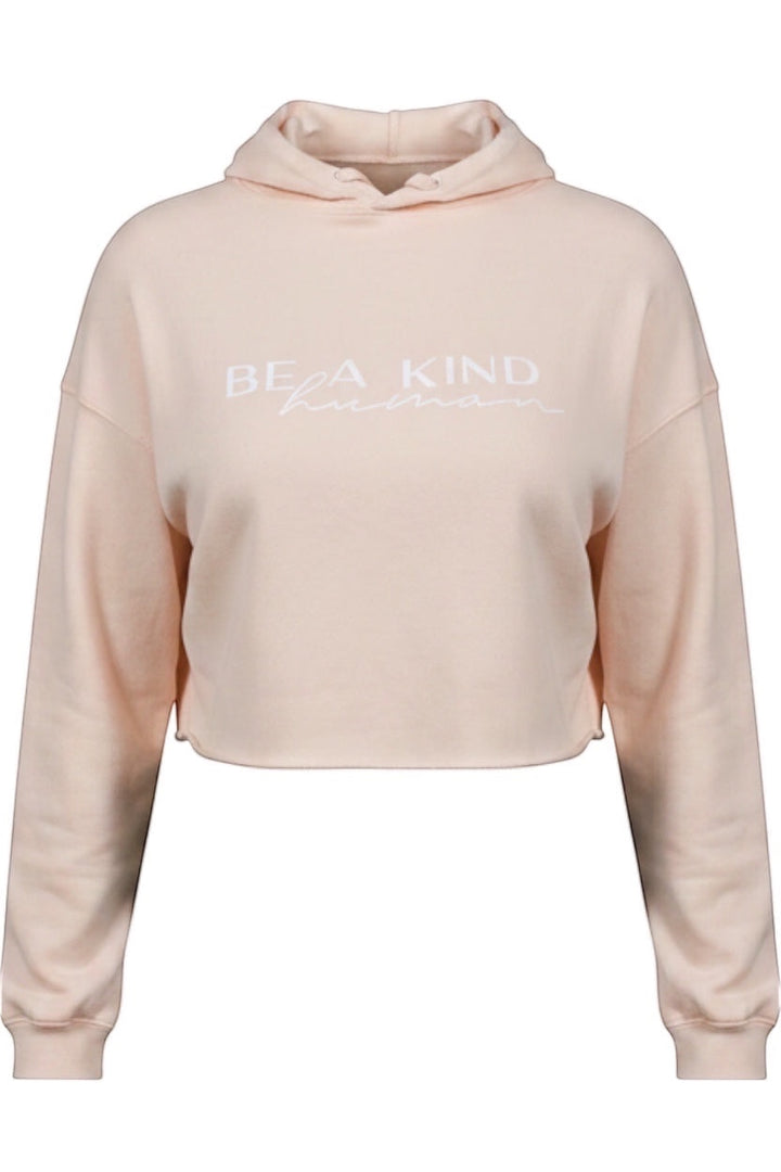 JSD Apparel light pink cropped hooded sweatshirt with Be A Kind Human text in white on the front