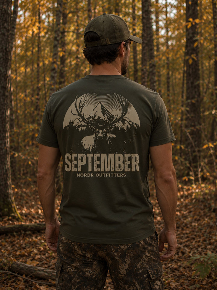 JSD Apparel olive green cotton t-shirt with vintage elk and mountain graphic, "SEPTEMBER NORDR OUTFITTERS" text.