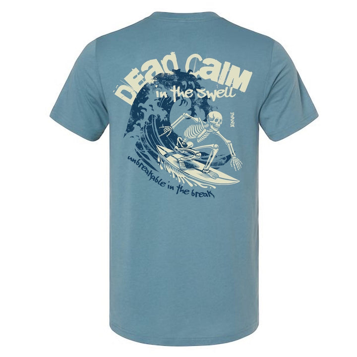 JSD Apparel blue cotton blend t-shirt featuring a back graphic of a skeleton surfing a wave with bold text.