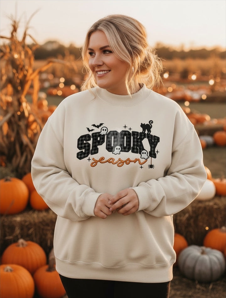 JSD Apparel cream mock neck sweatshirt with Spooky Season varsity plaid print and Halloween icons at a pumpkin patch