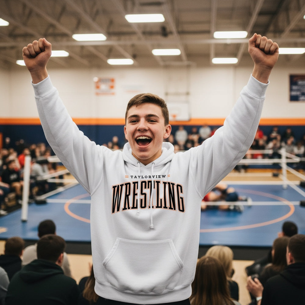JSD Apparel white pullover hoodie with Taylorview Wrestling graphic worn by a cheering fan at a wrestling match