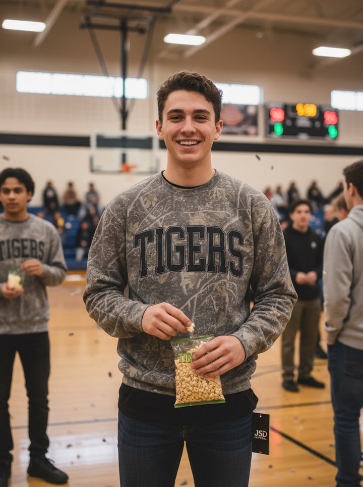 JSD Apparel Tigers crewneck sweatshirt in gray marble wash with black collegiate lettering worn by a smiling man