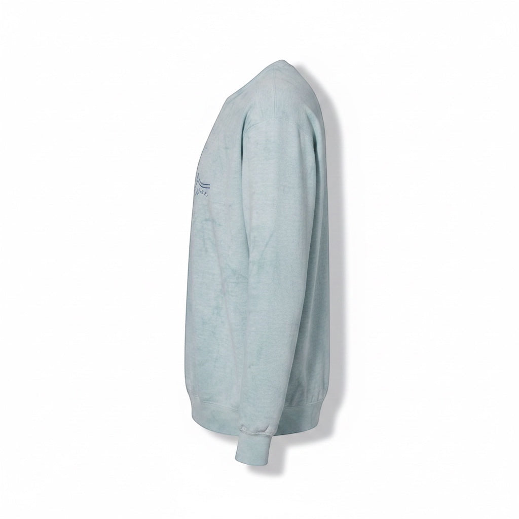JSD Apparel Ocean Wash Blue crewneck sweatshirt with a minimalist wave graphic and script logo. Cotton/poly blend.
