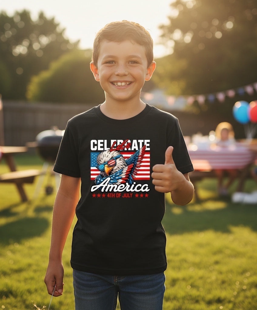 A smiling boy wearing a black JSD Apparel youth tee with a patriotic eagle graphic for 4th of July celebrations.